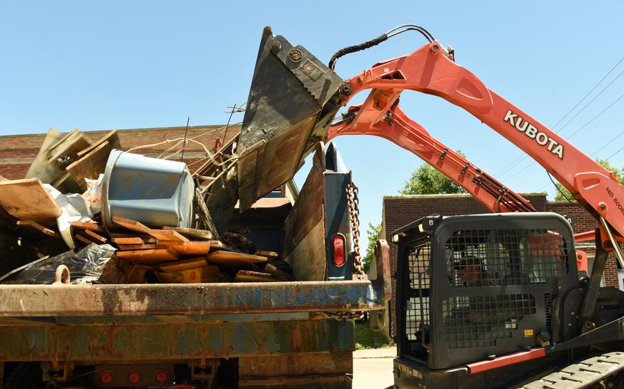 U.S. Air National Guard Staff Sgt. Seth Stamm dumps debris on a dump truck in Sioux Rapids, Iowa, June 30, 2024. Airmen were tasked by Iowa National Guard state headquarters to assist in debris cleanup in the wake of historic flooding in the state. 