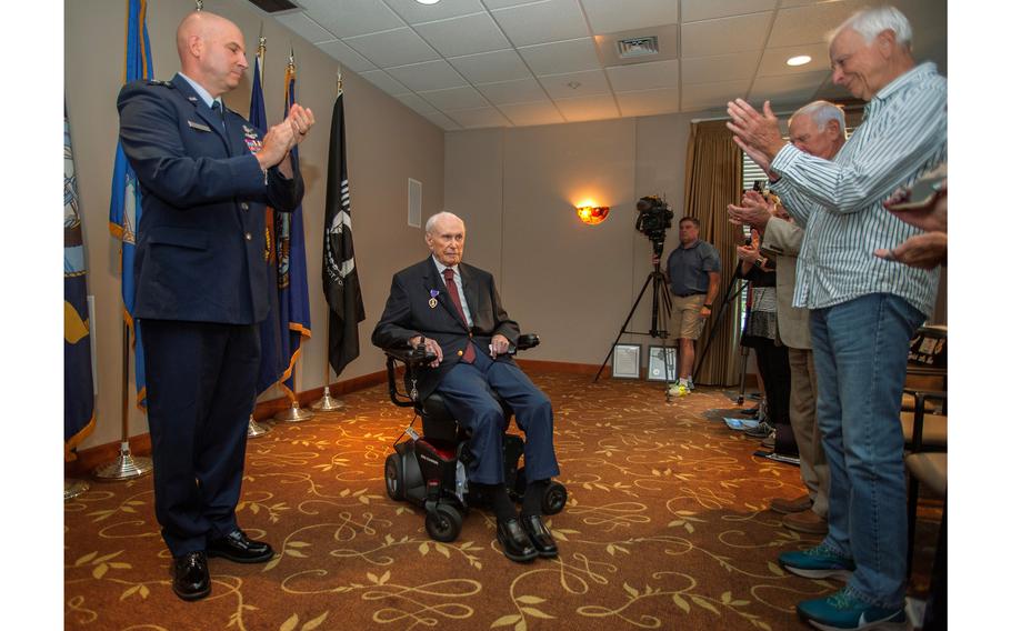 Malcolm Champagne, 102, receives applause from audience after Air Force Brig. Gen. Dean Sniegowski officially awarded the World War II veteran a long-delayed Purple Heart medal during a Sept. 15, 2023, ceremony in Portland, Ore.