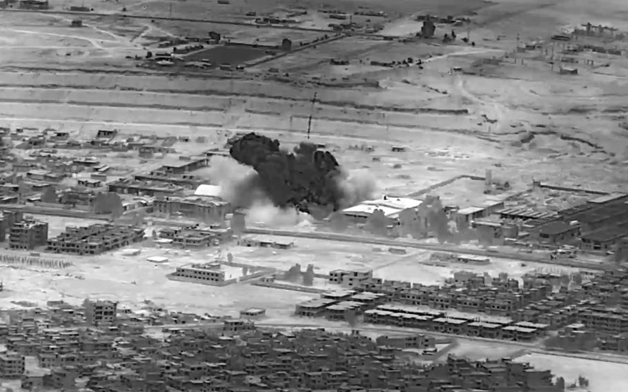 This image from video provided by the Department of Defense shows a Nov. 8, 2023, airstrike on a weapons warehouse, center, in eastern Syria. The strike targeted a facility linked to Iranian-backed militias, in retaliation for what has been a growing number of attacks on bases housing U.S. troops in the region for the past several weeks. 