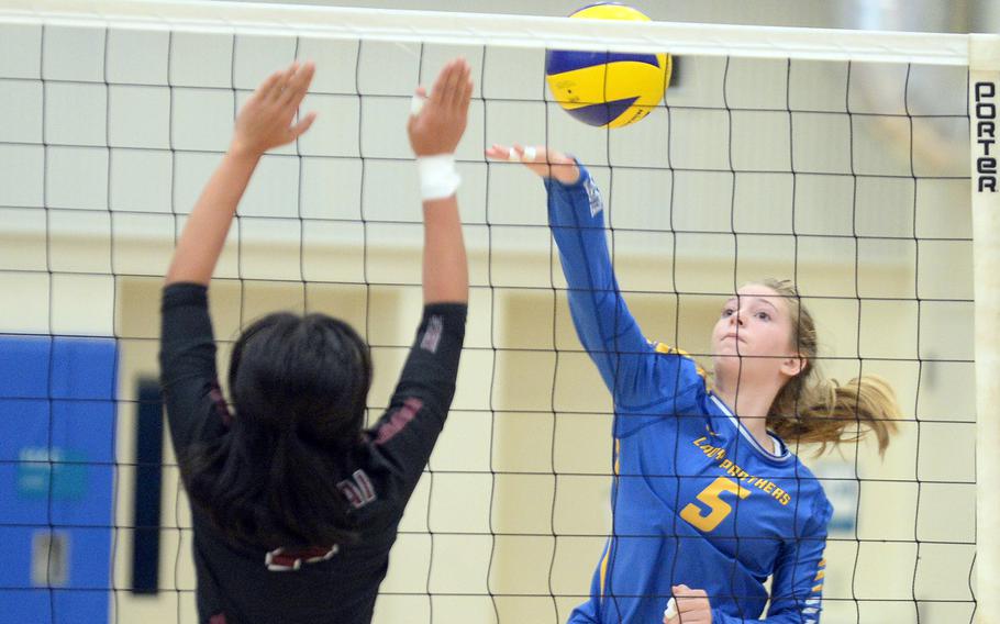 Yokota's Charlotte Rhyne spikes against Matthew C. Perry's Aiya Verzosa during Saturday's DODES-Japan volleyball match. The Panthers won in four sets.