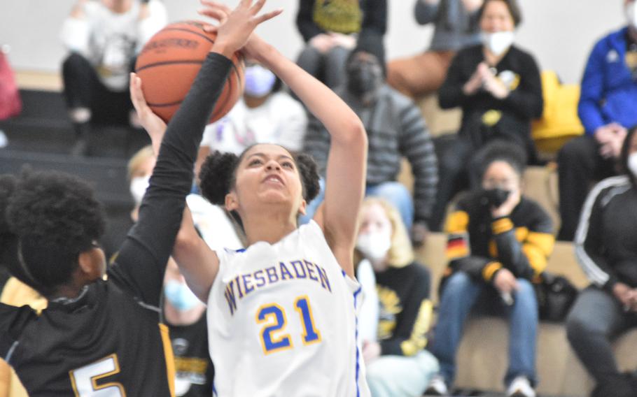Stuttgart's Skylar Cooper gets a hand out to stop a shot by Wiesbaden's Alynna Palacios on Saturday, Feb. 26, 2022 in the DODEA-Europe Division I girls championship game.
