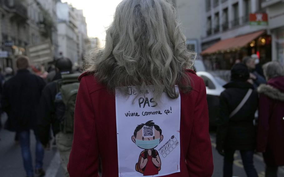 Demonstrators protest ongoing coronavirus restrictions in Paris, France, Saturday, Dec. 18, 2021. 