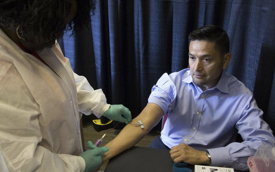 A blood sample is collected at the American Legion headquarters in Washington, D.C., in 2017 from a veteran participating in a long-term VA research program to develop a database of genetic information on veterans. 