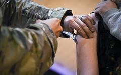 U.S. Air Force Capt. Angel Colon, 48th Medical Group operating room element leader, administers the Pfizer-BioNTech vaccine to a high school student at Royal Air Force Lakenheath, England, June 4, 2021. 