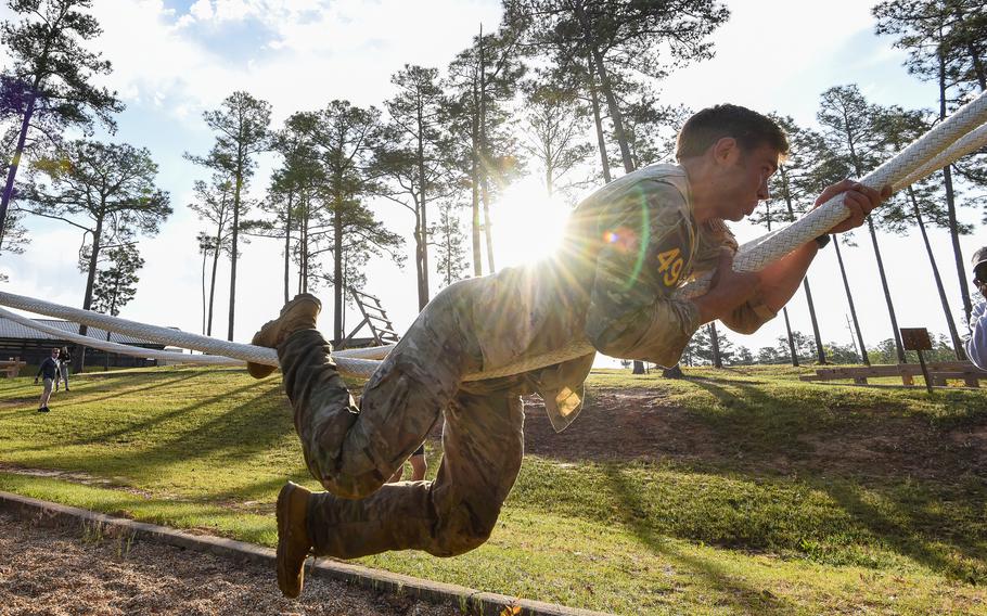 Sgt. 1st Class Michael Brown navigates a rope obstacle during the final day of the Army’s annual Best Ranger Competition on Sunday, April 14, 2024 on Fort Moore, Ga. 