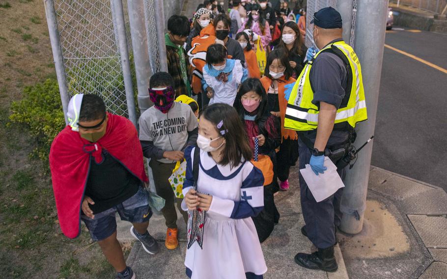 Trick-or-treaters enter the Dragon Vale housing area at Sasebo Naval Base, Japan, Oct. 31, 2021.
