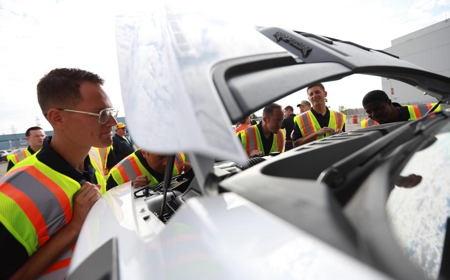 Brandon Franciscy, 25, checks out the wiring in the 2021 Ford F-150 Raptor engine while touring the Dearborn Truck plant with the Blue Angels on Aug. 3, 2021.