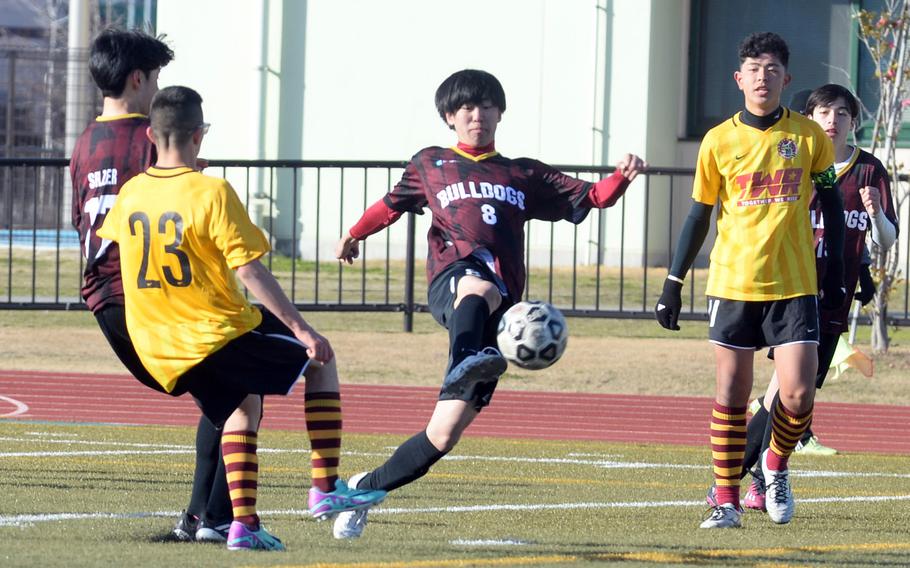 Marist's Jin Ushio sends a clearing pass between Perry's Anthony Salas and Ren Spinosi.