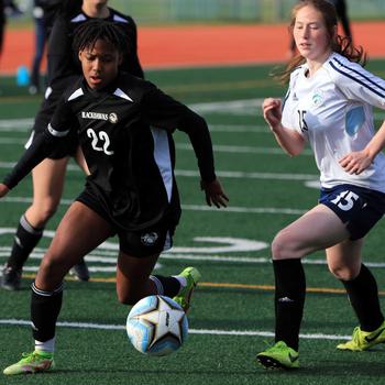 Humphreys’ Aria Freeman and Osan’s Hailee Clark chase the ball during Thursday’s DODEA-Korea soccer match. The teams played to a scoreless draw.