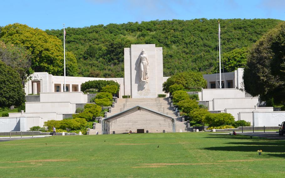 The walls of the Courts of the Missing stand on each side of grand steps at the National Memorial Cemetery of the Pacific in Honolulu. A pair of Vietnam War walls are at the forefront on each side.