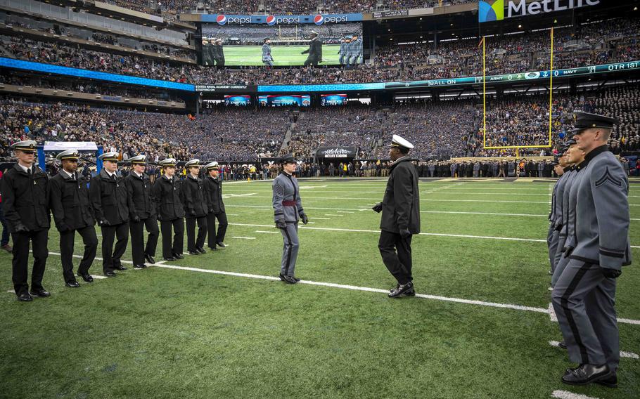 Midshipmen and cadets participate in the long-standing tradition, the “Prisoner Exchange,” in which cadets and midshipmen who have spent the previous semester at the opposite academy meet at midfield and are “returned” to their respective academies during the Army-Navy football game held at the MetLife Stadium, East Rutherford, N.J., on Dec. 11, 2021. Army-Navy football games will tour the Northeast over the next five years, the two institutions announced Wednesday, June 15, 2022.