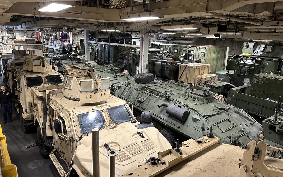 Joint light tactical and amphibious assault vehicles wait inside the well deck of the USS Makin Island in Busan, South Korea, Thursday, March 23, 2023.
