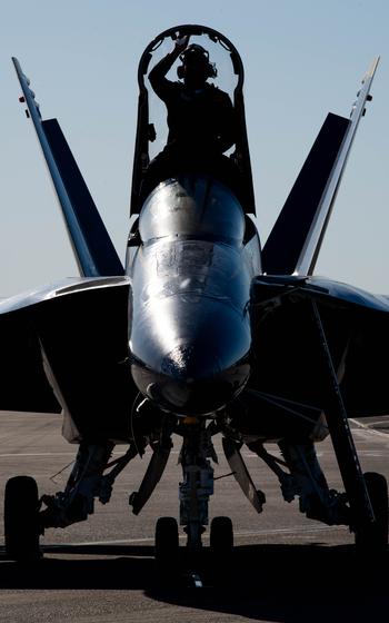 U.S. Navy Aviation Electronics Technician 2nd Class Michael Patterson III, Blue Angels crew chief, wipes down the canopy windows of Blue Angel #6 F/A-18 Super Hornet on the flight line at Travis Air Force Base, Calif., March 14, 2024. 