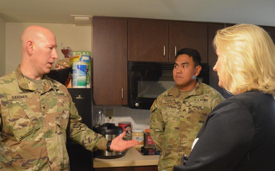 Brig. Gen. David Gardner, commander of Fort Polk, La., and Army Secretary Christine Wormuth speak with Sgt. Edward Peralta in his barracks room at the base Tuesday, April 25, 2023. Wormuth said it was a positive surprise to see the good condition of the barracks. 