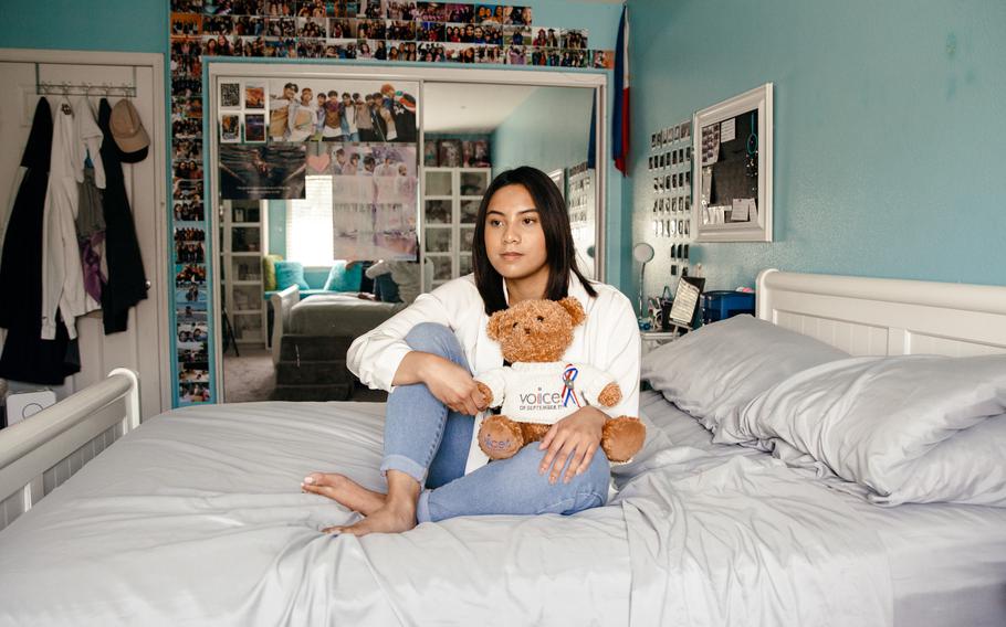 Robin Ornedo holds a teddy bear she received about 10 years ago at a 9/11 memorial event as a way to remember her father, Ruben Ornedo, who was killed in the attack. 