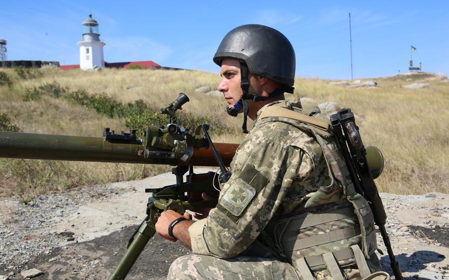 A service member of Ukraine's State Border Guard Service stands watch on Snake Island in August 2020. The island was attacked and taken by Russian troops on Feb. 25, 2022. The 13 personnel defending the island were killed after they refused to surrender to Russian warships, Ukraine's Foreign Affairs Ministry said.