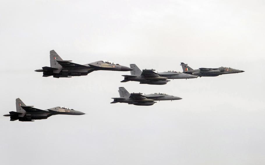 Two U.S. Navy EA-18G Growlers fly in formation with an Indian Air Force Jaguar, right, and two SU-30MKIs over the aircraft carrier USS Theodore Roosevelt during an exercise on the Indian Ocean, March 28, 2021. 