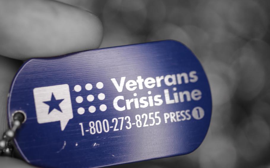 A photo illustration with the telephone number of the Veteran's Crisis Line. 