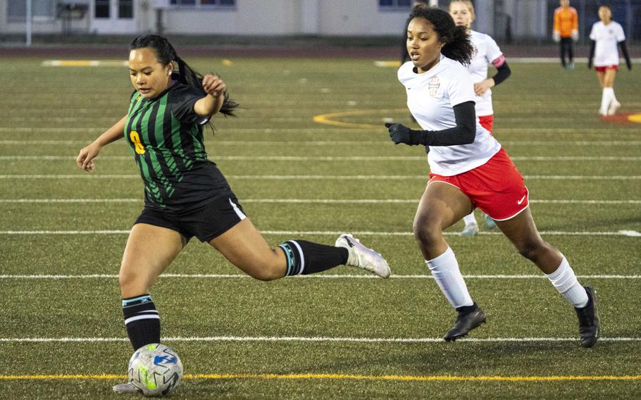 Robert D. Edgren's Amber Baltazar boots the ball ahead of Nile C. Kinnick's Alyssa Staples during Friday's DODEA-Japan girls soccer match. The Red Devils won 10-0.