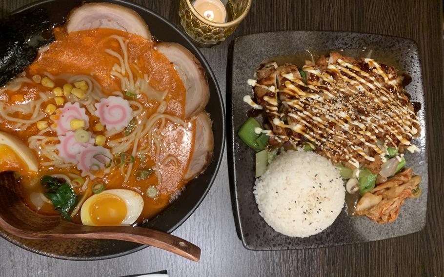 A large bowl of spicy red tonkotsu ramen and a crispy chicken teppanyaki meal are among the filling and flavorful options at Yunmi Asian fusion restaurant and bar located in Kaiserslautern, Germany.