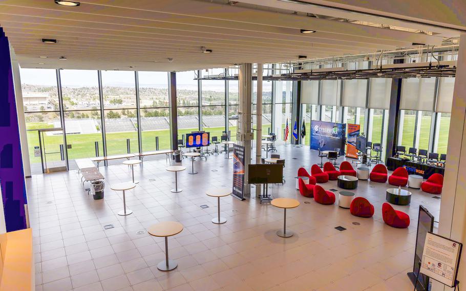 A large atrium with all-window walls looking out to a field.