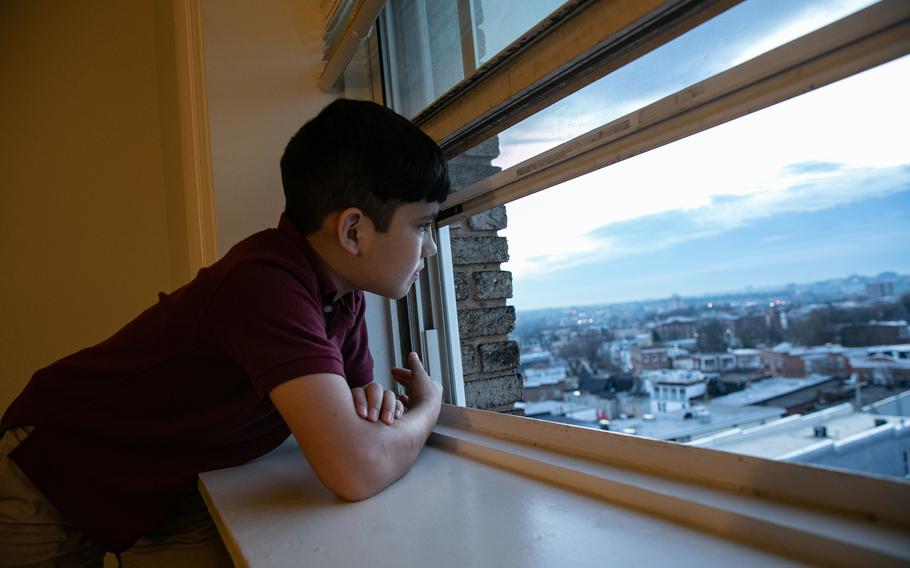Tabesh’s son Shafiq looks outside the family’s apartment in Baltimore.