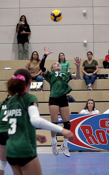 Naples' Emma Heavey jumps to hit the ball during the Wildcats' Division II semifinal match against the American Overseas School of Rome at the DODEA European volleyball championships on Friday at Ramstein High School on Ramstein Air Base, Germany.