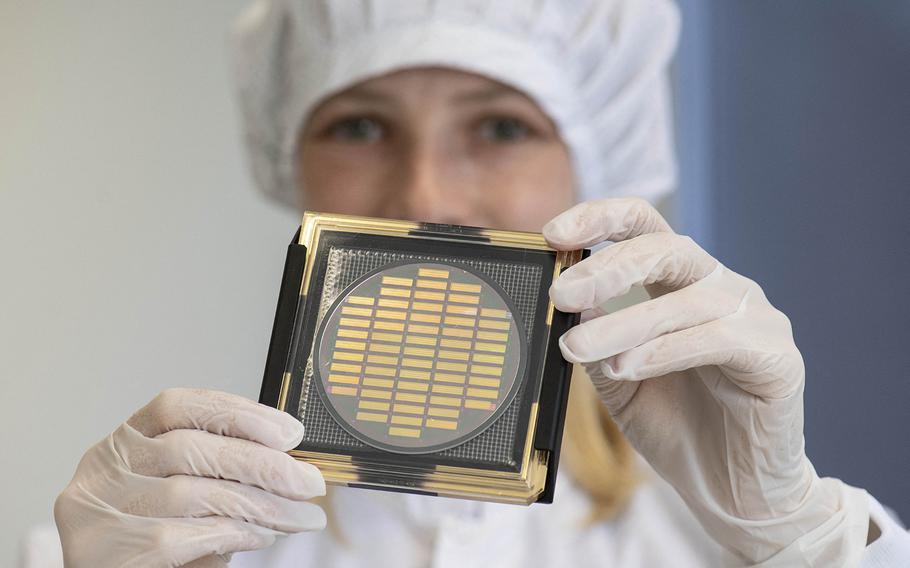 Engineer Hannah Wagenknecht shows a wafer with photonic chips for quantum computing at the technology company Q.ant in Stuttgart, southern Germany, on Sept. 14, 2021. (Thomas Kienzle/AFP via Getty Images/TNS)