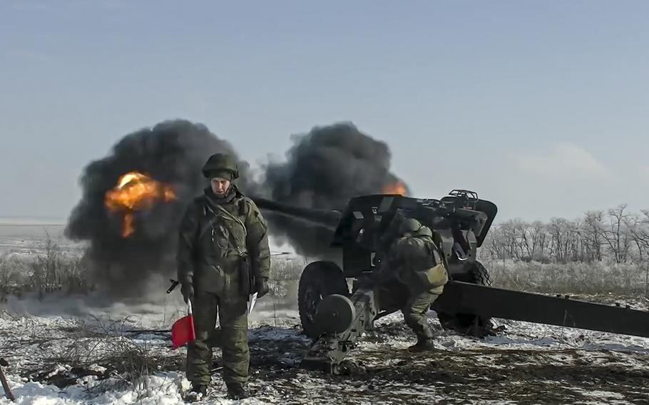 In this photo taken from video provided by the Russian Defense Ministry Press Service on Friday, Jan. 28, 2022, Russian troops fire howitzers during drills in the Rostov region during a military exercising at a training ground in Rostov region, Russia. 