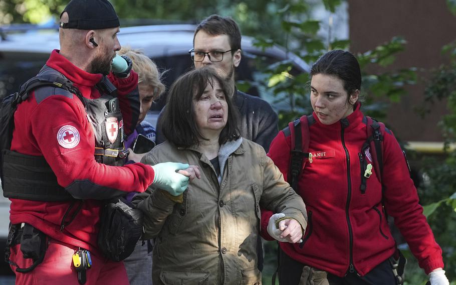 Medical workers help a woman 