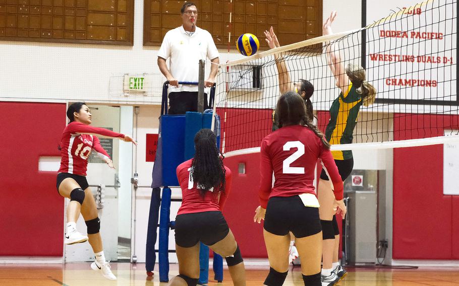 Nile C. Kinnick's Mikaila Joi Miranda tries to hit through the double block of Robert D. Edgren's Samara Whitmore and Kaitlyn Willets during Saturday's DODEA-Japan girls volleyball match. The Eagles won in four sets to split the weekend series with the Red Devils.