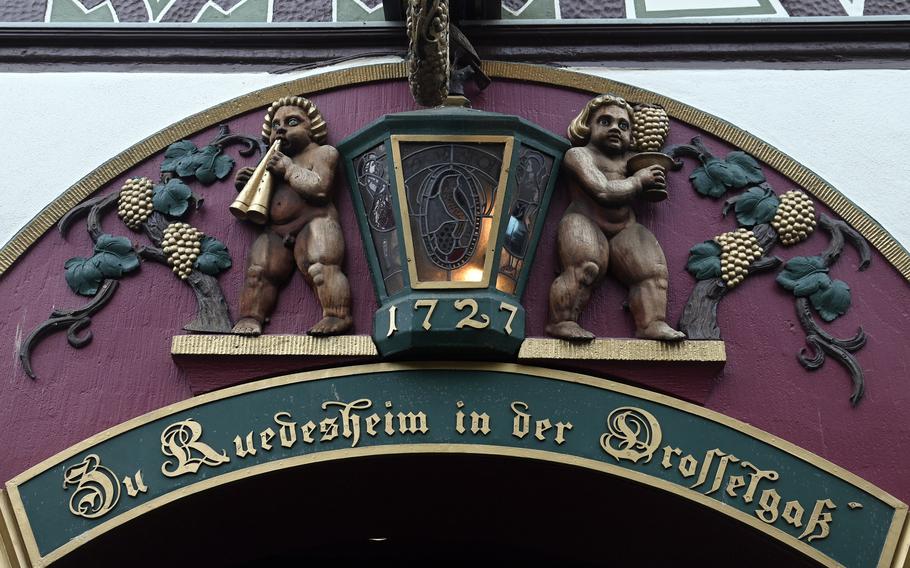 Ornate carvings decorate the door frame of the Drosselhof, the oldest inn on Drosselgasse, a wine tavern-lined pedestrian lane in Ruedesheim am Rheins old town.