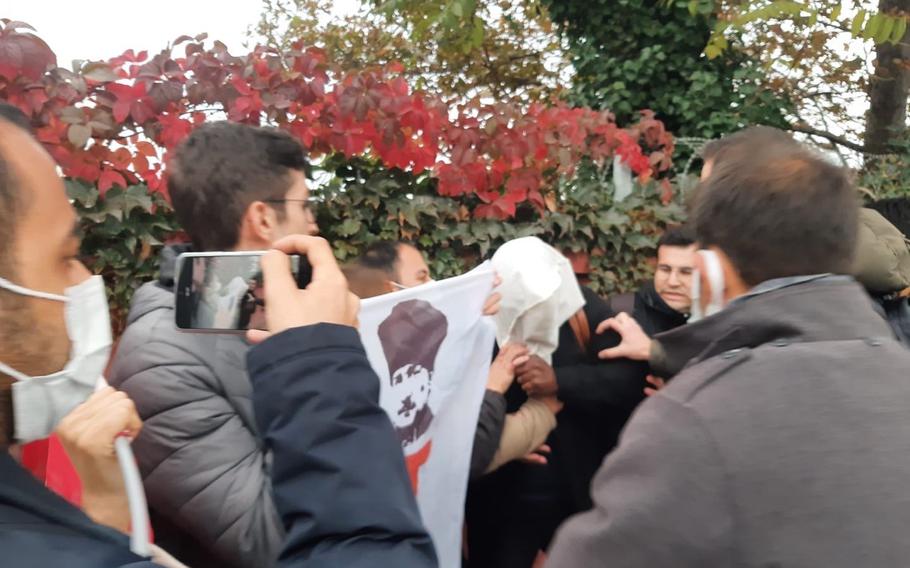 Protesters shouting anti-U.S. slogans surround and put a plastic bag over the head of a U.S. Navy civilian in Istanbul, Nov. 3, 2021. The Istanbul governor’s office announced the arrest of 17 individuals connected with the Youth Union of Turkey, which staged a similar protest in 2014.