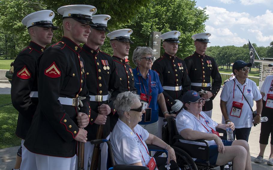 Members of a Marine Corps drill team greet participants of a special all-female Honor Flight trip to the Lincoln Memorial on the National Mall in Washington, D.C., on Tuesday, May 31, 2022. Sitting in a wheel chair at left is World War II Army veteran Ruth Jones, 97.