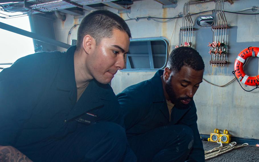 Seaman Luis Mancera, left, seen here alongside Seaman Jordan Charles on Oct. 25, 2022, died aboard the USS Ronald Reagan on Jan. 8, 2024. 