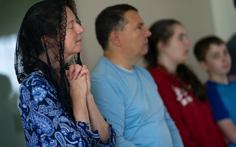 Julie Meyer, of Gaithersburg, Md., prays with her family during a mass at Saint Paul Catholic Church in Damascus, Md., on June 5, 2021. 