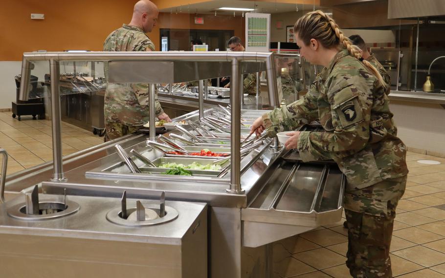 A soldier makes a salad at a dining facility at Fort Knox, Ky, on April 12, 2023.
