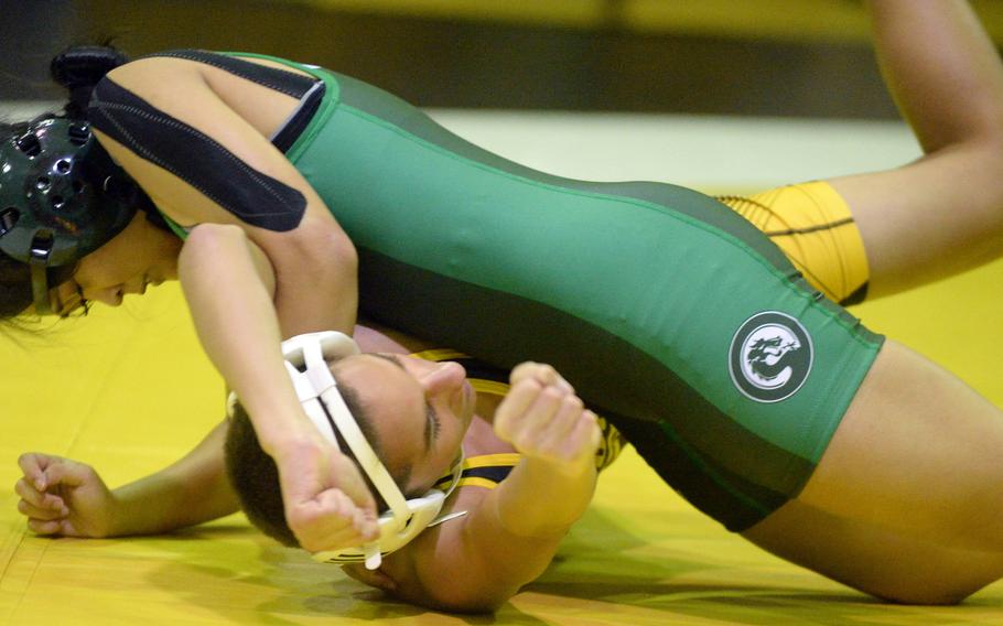 Kubasaki’s Gwen Panteleon gains the upper hand on Kadena’s Jayden Green at 101 pounds during Wednesday’s Okinawa wrestling dual meet. Panteleon won by technical fall 10-0 in 1 minute, 20 seconds and the Dragons took the meet 40-23.