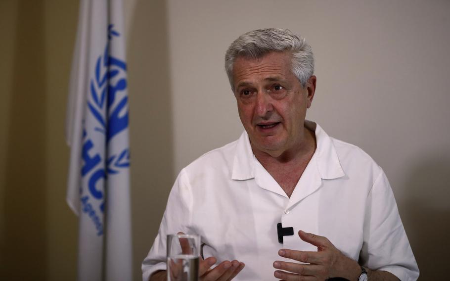 A man in a white shirt speaking.