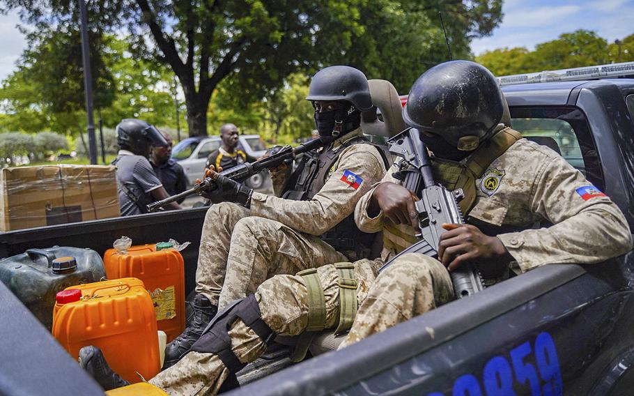 Haitian police collect fuel as they patrol in Port-au-Prince on July 15, 2022. 