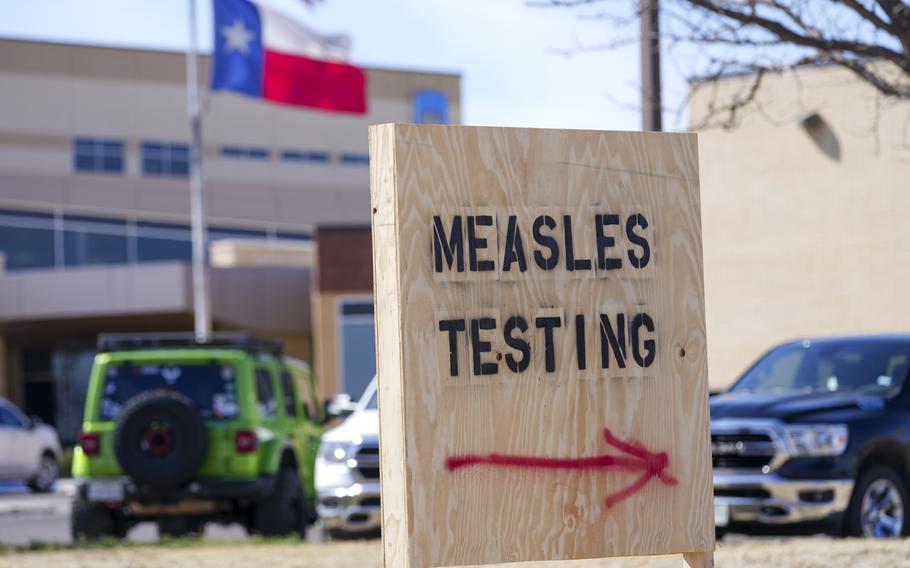 A wooden sign that says “Measles Testing.”