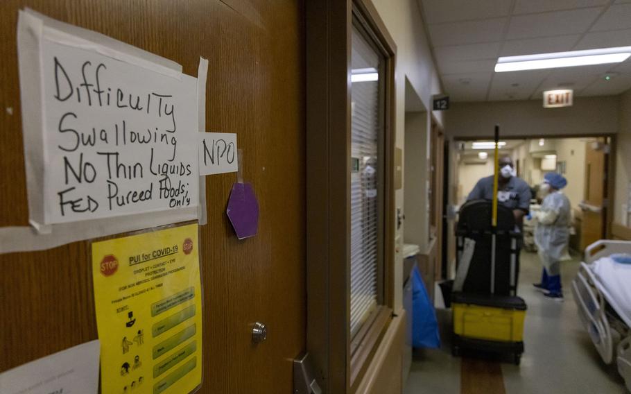 A purple hexagon marks a patient’s room as positive for COVID-19 in the emergency department on Jan. 12, 2022, at Loretto Hospital in Chicago.