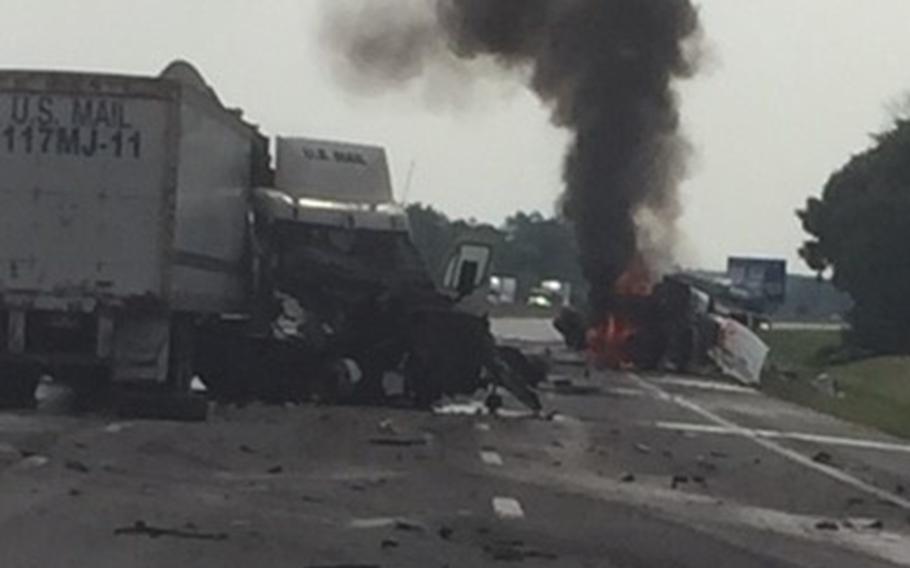 A truck is on fire while two other trucks lay in ruins on a highway near Sandusky, Ohio, on Aug. 20, 2018. Randy Wilson received the Air Force Civilian Award for Valor after he helped pull the driver from the burning rig just before it exploded.