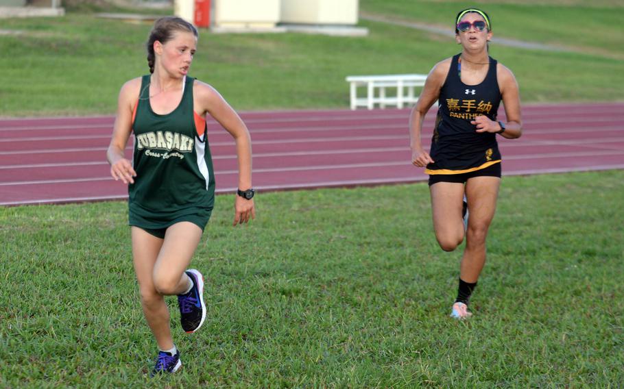 Kubasaki’s Billi Readinger and Kadena’s Mia Bella Gonzalez approach the finish line a second apart during Wednesday’s Okinawa cross country meet. Readinger was first in 23 minutes, 14.8 seconds, followed by Gonzalez in 23:15.8.