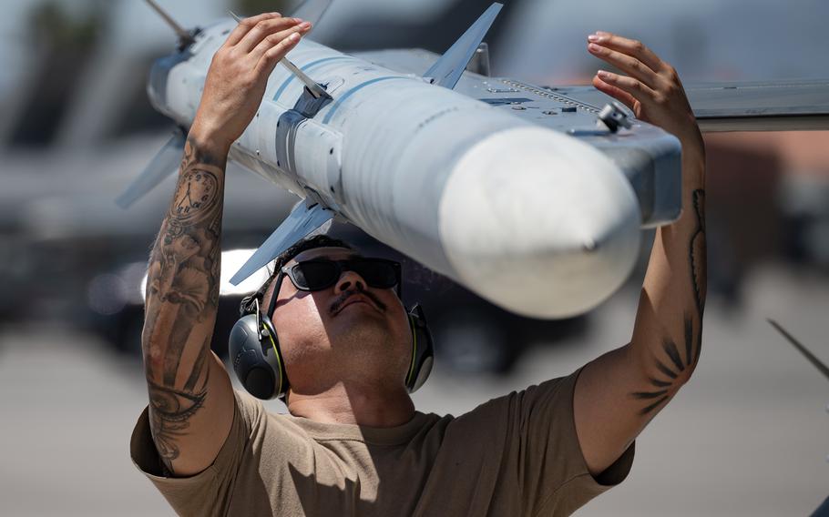 Air Force Tech. Sgt. Nathaniel Small, of the 113th Wing, makes final checks on an F-16 Fighting Falcon before a Red Flag 23-3 training mission at Nellis Air Force Base on July 19, 2023.