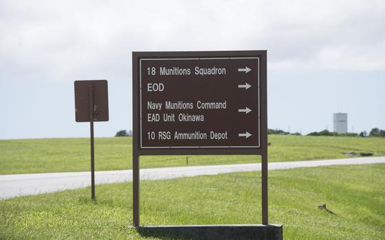 A sign reads “18th Munitions Squadron,” “EOD,” “Navy Munitions Command EAD Unit Okinawa,” and “10 RSG Ammunition Depot.”