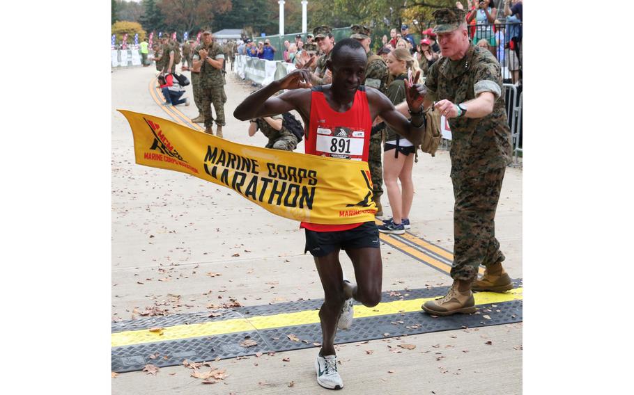 Julius Kogo crosses the finish line as the winner of the Marine Corps Marathon on Sunday, Oct. 29, 2023, in Arlington, Va. Kogo was timed in 2:25:56 on a cloudy, warm day.