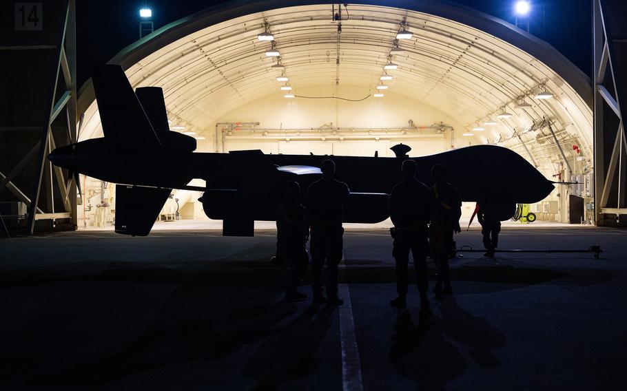 Airmen with the 319th Expeditionary Reconnaissance Squadron prepare to move an MQ-9 Reaper into an aircraft shelter at Kadena Air Base, Okinawa, Oct. 13, 2023.