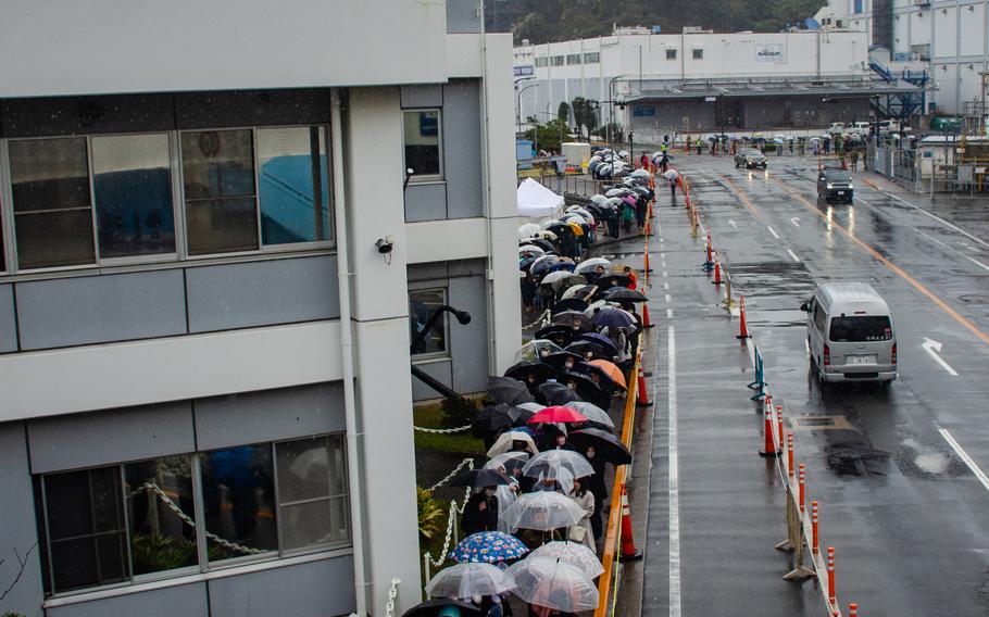 Hundreds line the sidewalks waiting to tour the USS Blue Ridge and USS Benfold during the Spring Festival at Yokosuka Naval Base, Japan, on March 25, 2023. 