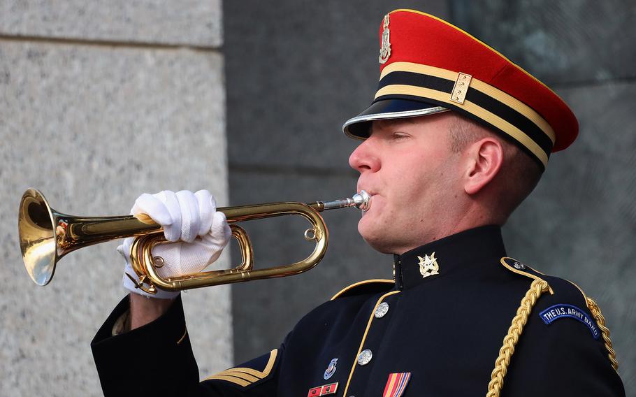 An Army bugler plays taps to conclude the Veterans Day ceremony at the National World War II Memorial in Washington, November 11, 2023.